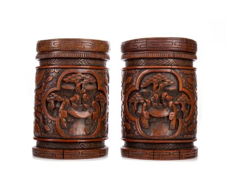 PAIR OF CHINESE BAMBOO BRUSH POTS/TOBACCO JARS,carved in high relief with scenes of figures in natural landscapes against flo