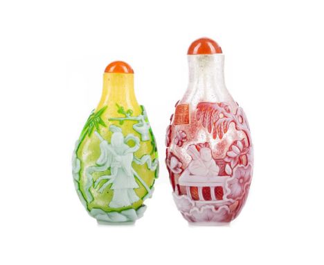 TWO CHINESE PEKING-TYPE CAMEO GLASS SNUFF BOTTLES,both decorated with figures in garden settings, both with Qianlong seal mar