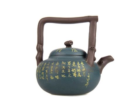 20TH CENTURY CHINESE YIXING POTTERY TEAPOT,with moulded bamboo-effect handle and bearing incised calligraphic script, impress