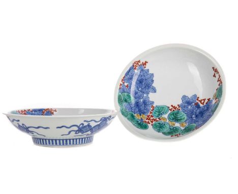 PAIR OF JAPANESE BOWLS,decorated in the kakiemon palette, with floral sprays, with underglazed blue Buddhist ribbons to the e