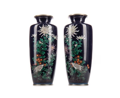 PAIR OF EARLY 20TH CENTURY JAPANESE CLOISONNE ENAMEL VASES,of tapered form, decorated with cranes, chrysanthemum and flowerin