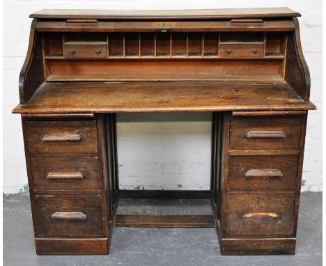 American oak roll top desk, serpentine tambour enclosing interior fitted with drawers and pigeon holes, twin pedestals each f