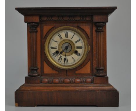 Stained beechwood mantel clock, 4 1/2" circular dial with Roman numerals, bracket feet, movement striking on a bell and gong,