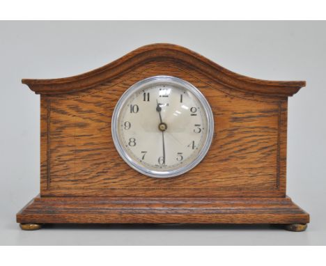 Oak cased mantel clock, arched top with a moulded cornice, circular dial signed Ferranti, surrounded by stringing, plinth bas