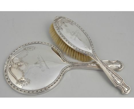 Silver mounted hand mirror and brush, embossed with flowers, engraved Alice, silver mounted brush and comb, (4).
This lot is 