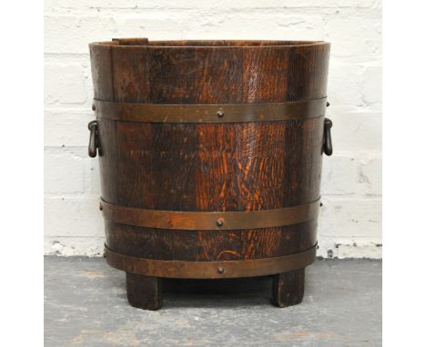 Oak log bin, brass bands labelled R A Lister & Co., Woodcroft, Dursley, diameter 37cm, height 40cm.