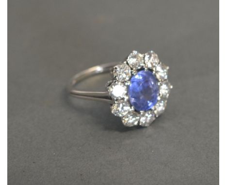 An 18ct White Gold Sapphire and Diamond Cluster Ring with a central sapphire surrounded by diamonds, approximately 2ct diamon