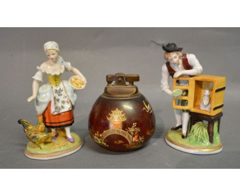 A Carlton Ware Rouge Royale Table Lighter, together with a pair of German porcelain figures