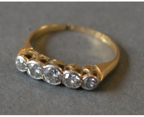 An 18ct Yellow Gold Five Stone Diamond Ring with five graduated diamonds within a pierced setting