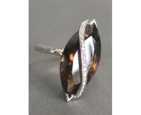 An 18ct. White Gold Citrine and Diamond Ring, set with a large navette citrine with a band of diamonds within a pierced setti