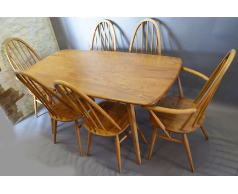 An Ercol Blonde Dining Suite comprising a refectory style dining table and six high stick back chairs with panel seats raised