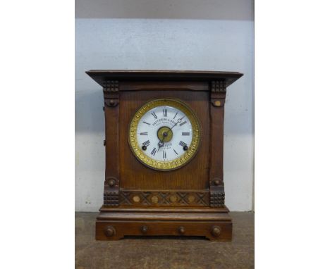 A Victorian oak Fattorini &amp; Sons oak mantel clock 