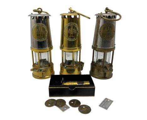 Miners brass safety lamp by Protector Lamp and Lighting Co., two others, a miniature lamp inscribed 'Manvers Main Colliery', 