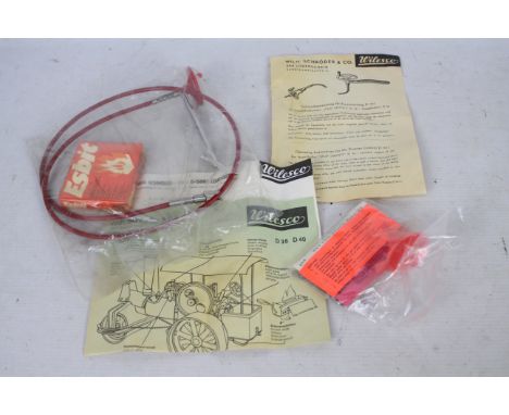 Wilesco - An unused Wilesco steam tractor accessory bag containing the driving wheel and cable, instruction sheet, funnel, sp