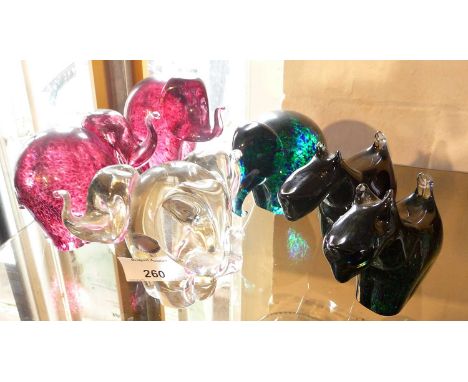 Four Wedgwood glass paperweight elephants including three headed elephant together with a pair of Scottie Dogs 