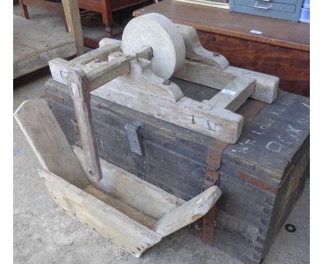 Antique wooden framed grindstone and a iron bound trunk.