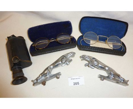 Pair of vintage chrome Jaguar car mascots, two pairs of cased spectacles and a monocular