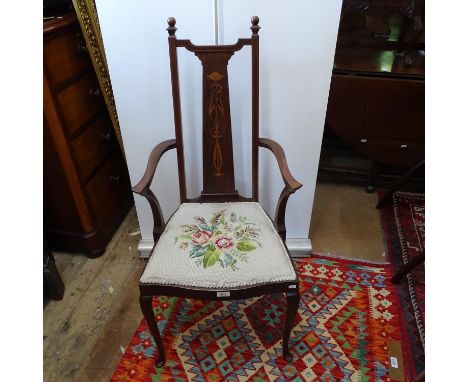 An Art Nouveau walnut armchair, with stylised marquetry panelled back and tapestry seat 