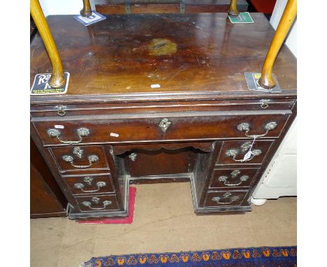 An 18th century Cuban mahogany kneehole desk in Chippendale style, with brushing slide and single frieze drawer under, with c