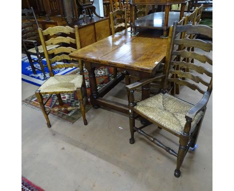 A rectangular oak plank-top refectory dining table, on baluster turned legs, together with a set of 8 matching ladder-back an