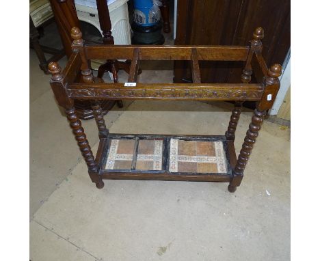 A 1920s oak stick-stand on bobbin turned legs 