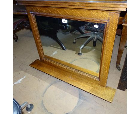 A 1920s oak-framed wall mirror with shelf, W89cm, H68cm 