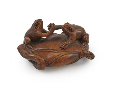WOOD NETSUKE OF TWO WRESTLING FROGS MEIJI PERIOD carved as two frogs 'arm wrestling' on a curled leaf, the base incised with 