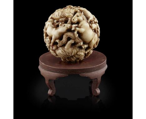 JAPANESE IVORY BALL, MEIJI PERIODfinely carved with animals and a dragon, a seal marked 'Masamitsu', with a wooden stand5.5cm