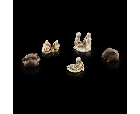 GROUP OF IVORY AND WOOD NETSUKE AND OKIMONO, MEIJI PERIODcomprising a small ivory okimono of three figures seated in various 