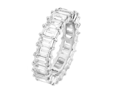 Circa 1950s 6.85 Carat TW Emerald Cut Diamond and Platinum Eternity Band. Diamonds E-F-G color, VS1-VS2 clarity with a few SI