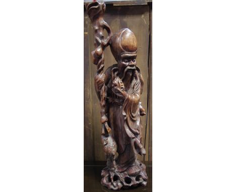 A Japanese root wood figure, as Shou Lao, stood with staff, gourd flask,pierced base, 61cm high 