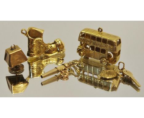 A 9ct gold London Double Decker bus charm 7.7g; a 9ct gold old boot charm 6.4g; a 9ct gold house keys and return label charm 