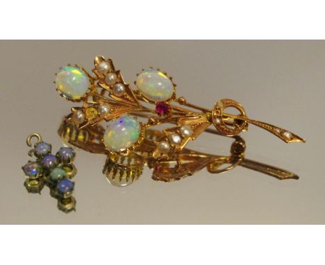 An Edwardian opal garnet and seed pearl floral spray brooch, 9ct gold mount; a small cross (2) 