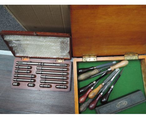 A box of vintage tools, including chisel, plane, depth gauges etc.
