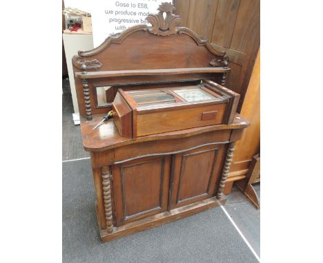 A mid Victorian mahogany chiffonier having raised mirror back over serpentine frieze drawer with cupboard under, flanked by b