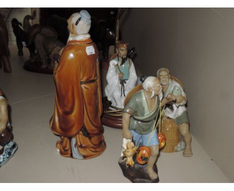 Four 'Mud Men' figurines including table lamp