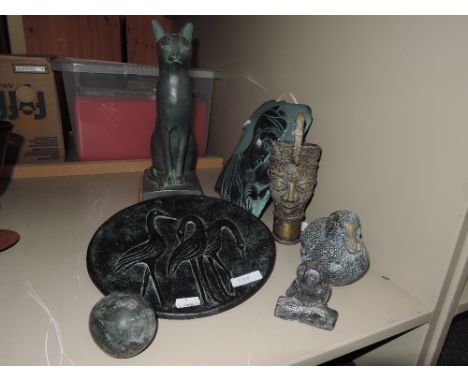 A selection of resin and ceramic figures and wall plaques