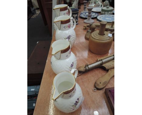 Four graduated Coalport Caughley mask-head jugs 