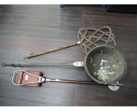 A large brass ladle, shooting stick and carpet beater.