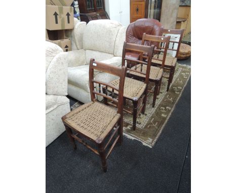 A set of four early 19th century stained frame vernacular chairs having rail and bobbin backs with later sea grass seats on t