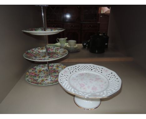 A Midwinter floral chintz cake stand and cake stand with pink flower decoration