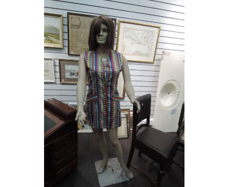 A 1960's female mannequin on stand