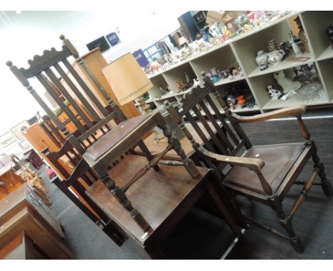 A 1920's oak carver chair having crest and slat backs and bobbin frame and a similar standard chair