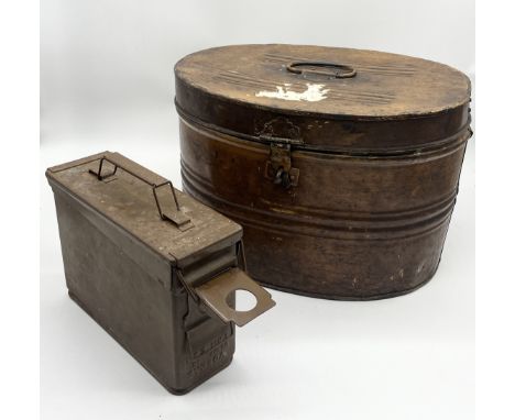 A vintage tin hat box along with an ammo box 