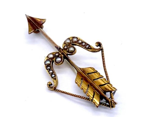A Victorian 15ct (tested) brooch in the form of Cupid's bow and arrow, decorated with seed pearls (pin not gold), total weigh