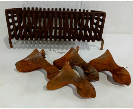 A vintage cast iron fire basket,47cm wide,30cm deep and a set of four cast iron ball in claw feet for a bath.