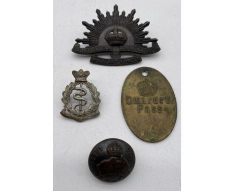 A brass Omaruru Pass, 52mm x 35mm along with an Australian Commonwealth Military Forces cap badge (indistinct name to inside)