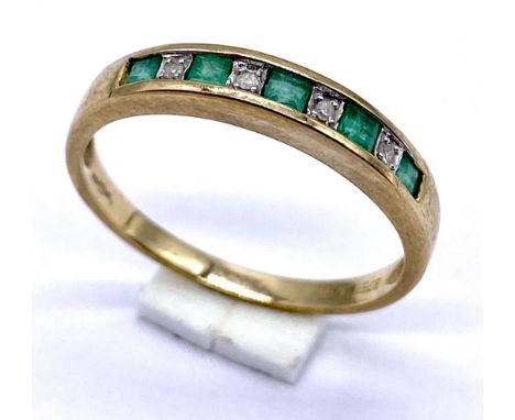 A 9ct gold emerald and diamond channel set half eternity ring, size P - total weight 1.8g