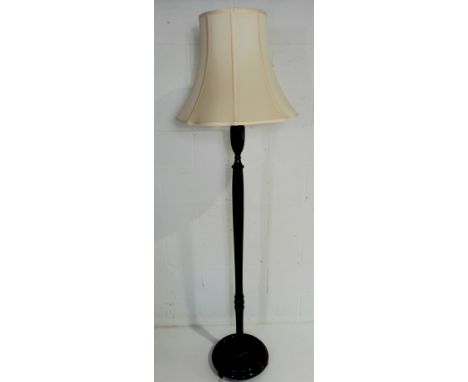 A mahogany standard lamp, with cream silk shade.