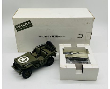 A boxed Danbury Mint die-cast model of a WWII military Jeep replica, finished in military green with USA Star transfer and lo